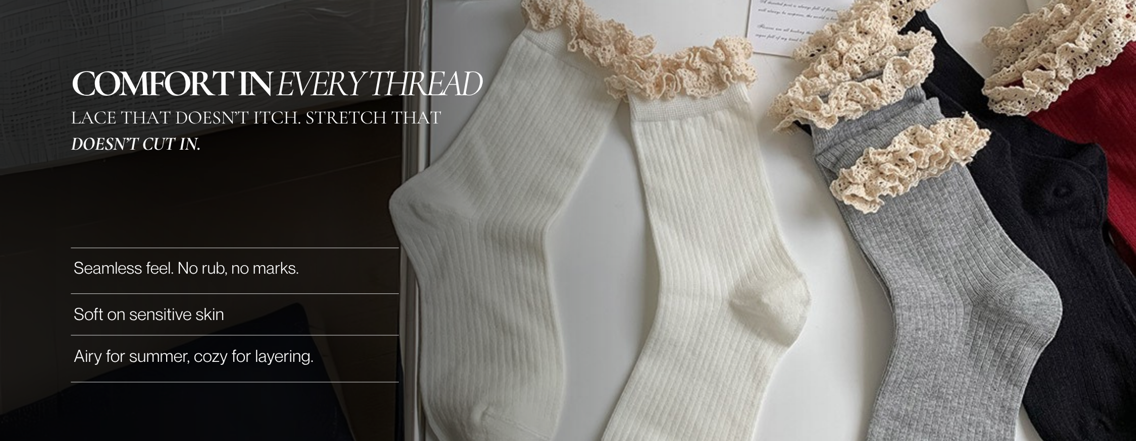 Flat lay of ribbed lace-trim socks in ivory, grey, black, and red, featuring frilly cream ruffle edges on a white surface.