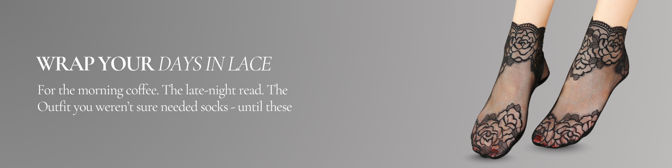 Model wearing sheer black lace ankle socks with floral embroidery, styled against a soft grey background.