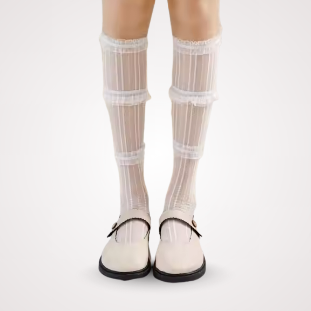 Model wearing sheer white mid-calf lace socks with layered frills and vertical stripes, styled with cream Mary Jane shoes.