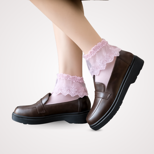 Model wearing pink lace cuff crew socks with brown loafers, featuring delicate scalloped trim and soft sheer fabric.