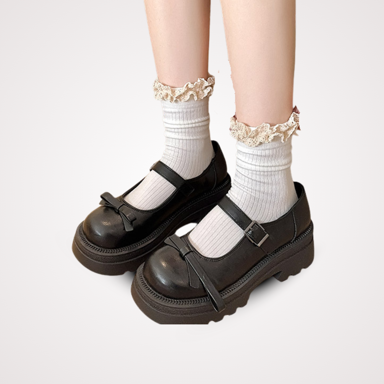 Model wearing white ribbed crew socks with cream frilly lace trim, styled with black platform Mary Jane shoes.